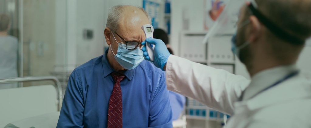 Doctor checking patients body temperature at the dental