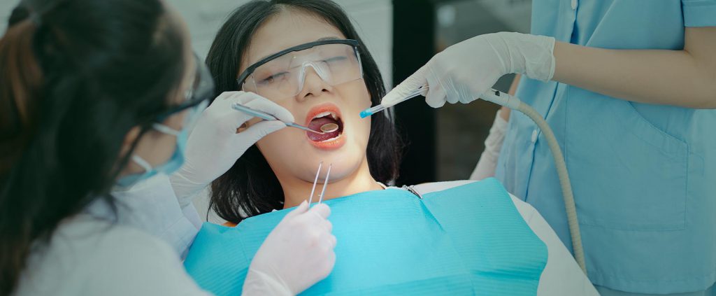 Woman having surgery at dental clinic