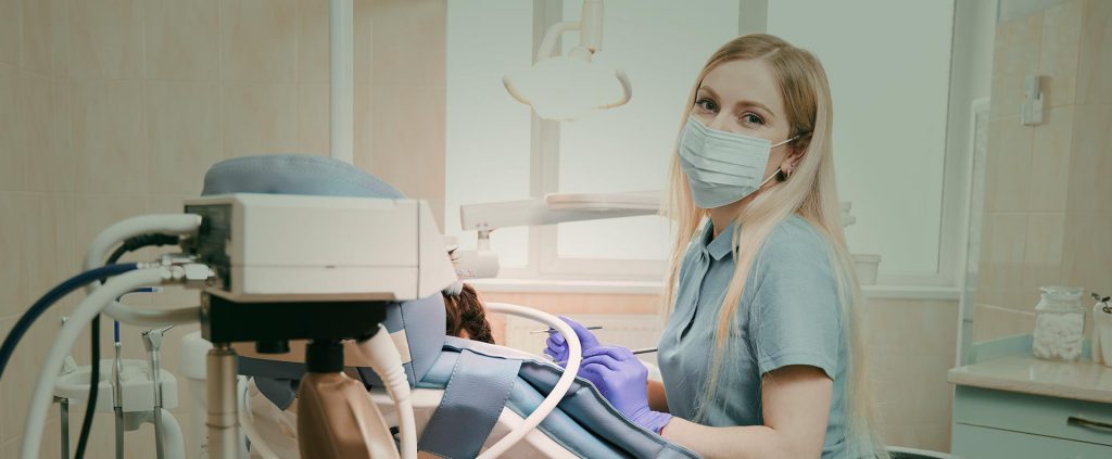 Dentist smiling at her practice